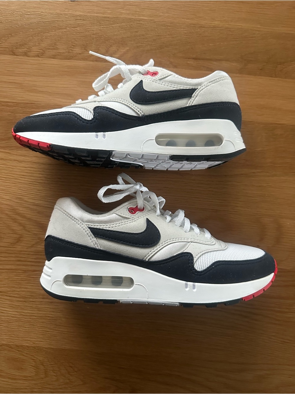 Nike Air Max 1's        White Sneakers with Dark Blue and Red Accents